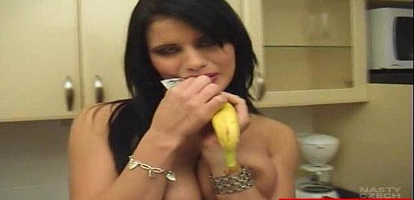  Big-titted brunette plays with a banana